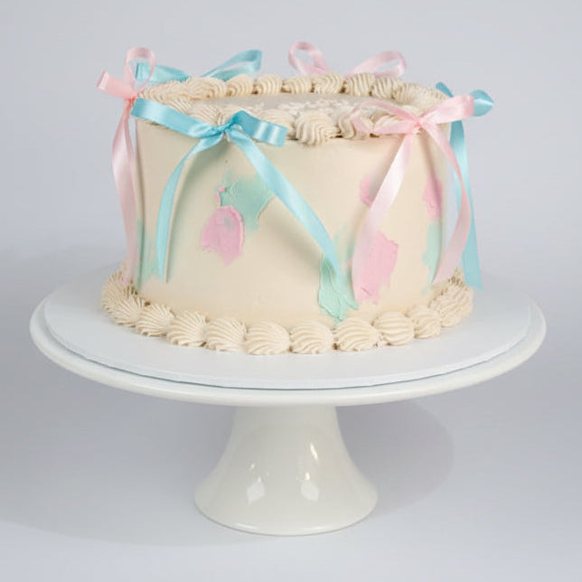 White Gender Reveal Cakette with bows by Perth Cake and Cookie Co.